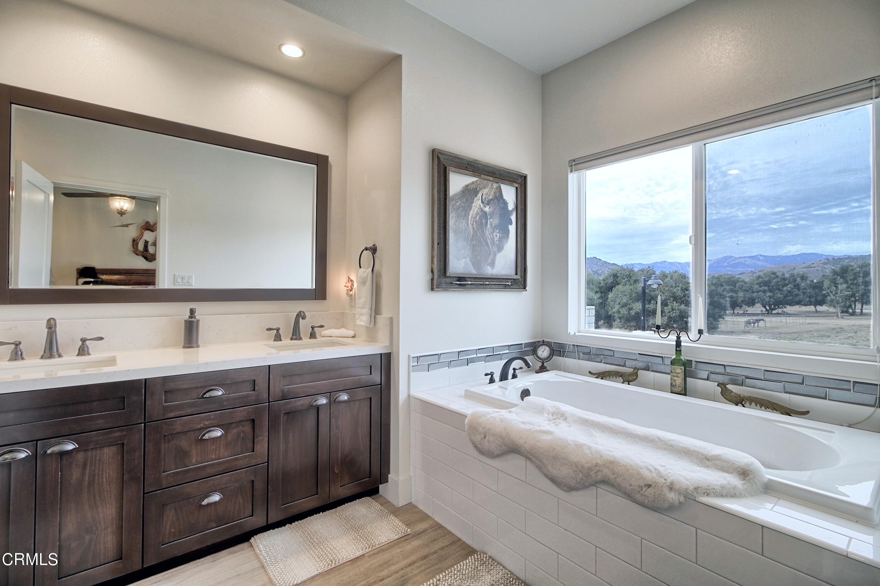 357 Los Cabos Lane Ventura, CA 93001 - Photo 15 of 44 a en suite bathroom with a double vanity sink and a large mirror