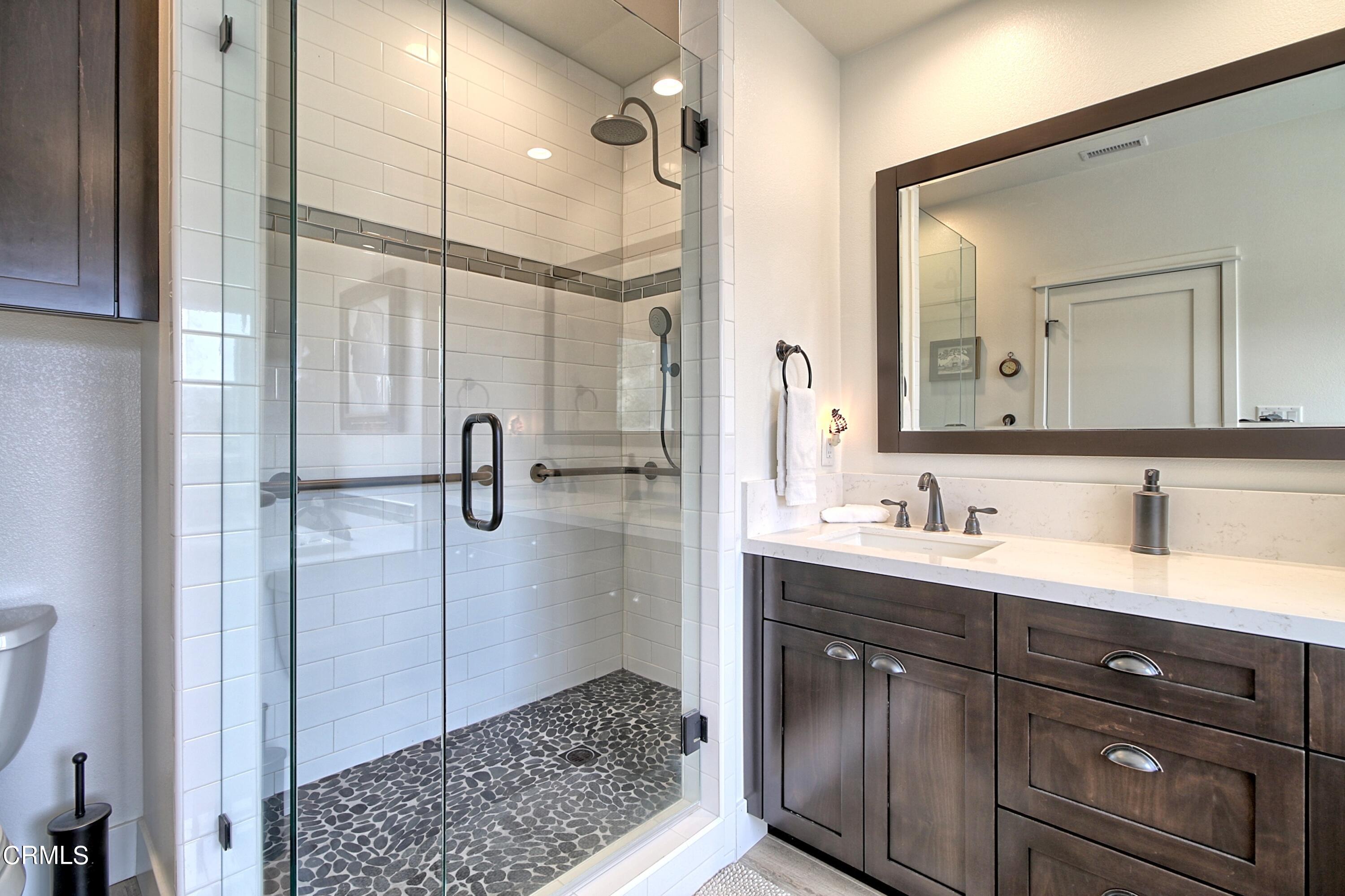 357 Los Cabos Lane Ventura, CA 93001 - Photo 17 of 44 a bathroom with a shower sink and mirror