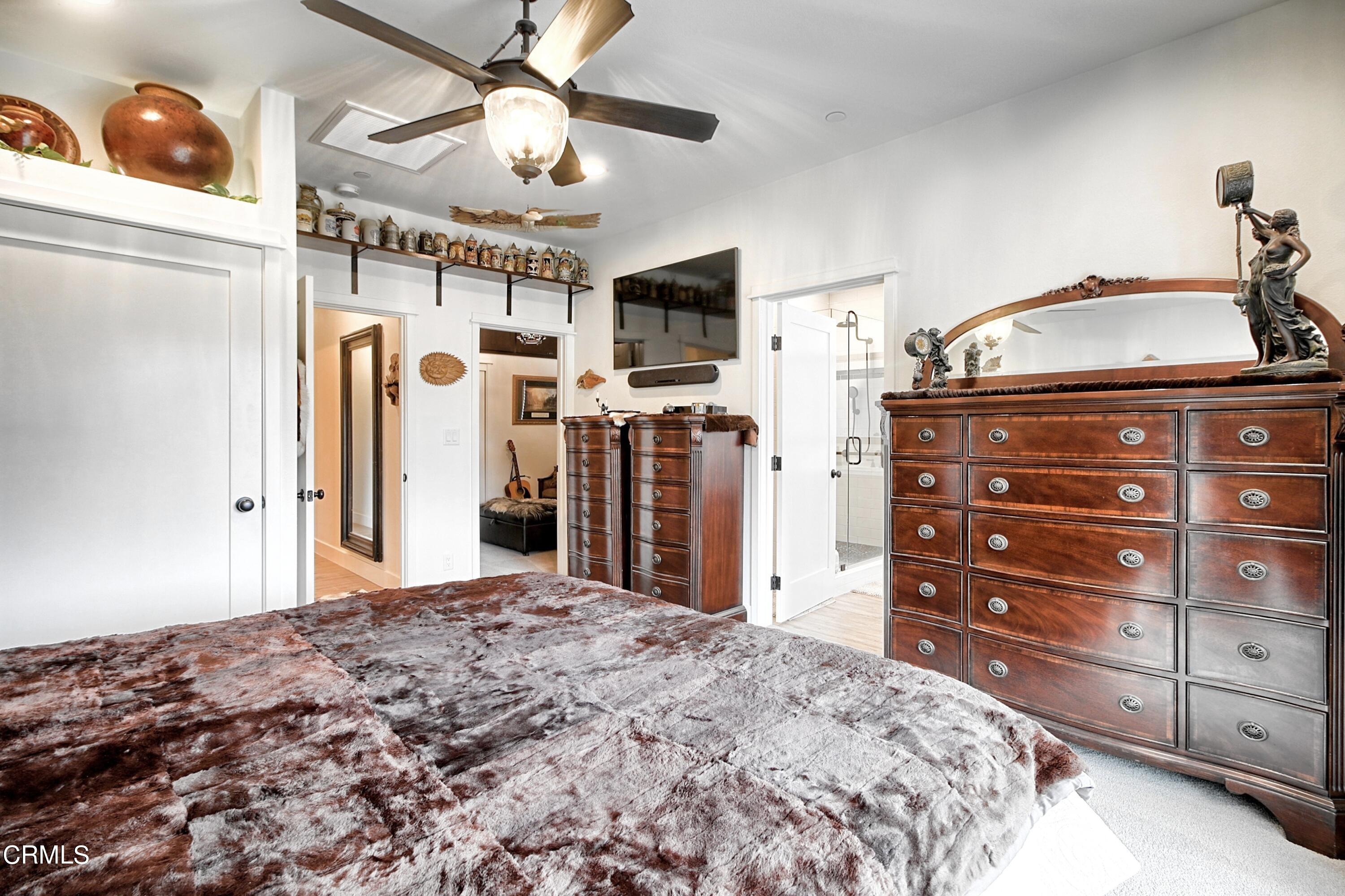 357 Los Cabos Lane Ventura, CA 93001 - Photo 18 of 44 a bedroom with a bed and a flat tv screen on dresser