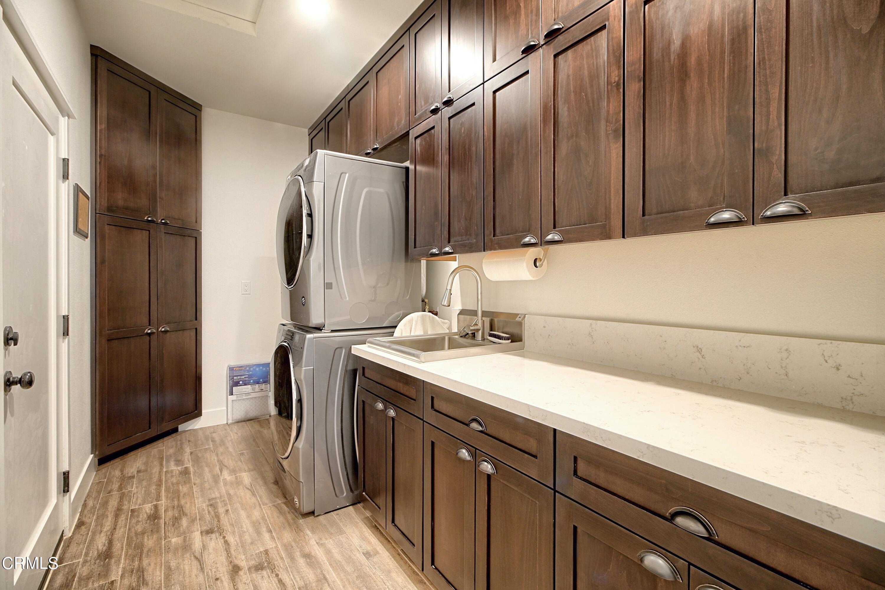 357 Los Cabos Lane Ventura, CA 93001 - Photo 22 of 44 a kitchen with a sink and a refrigerator