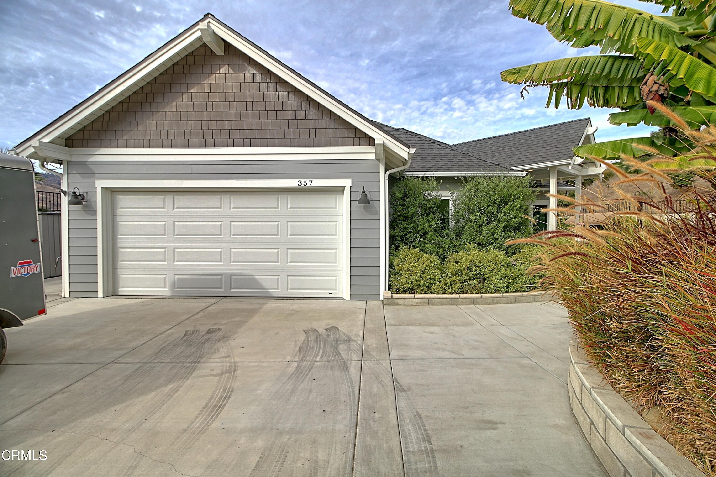 357 Los Cabos Lane Ventura, CA 93001 - Photo 33 of 44 a front view of a house with a yard and garage