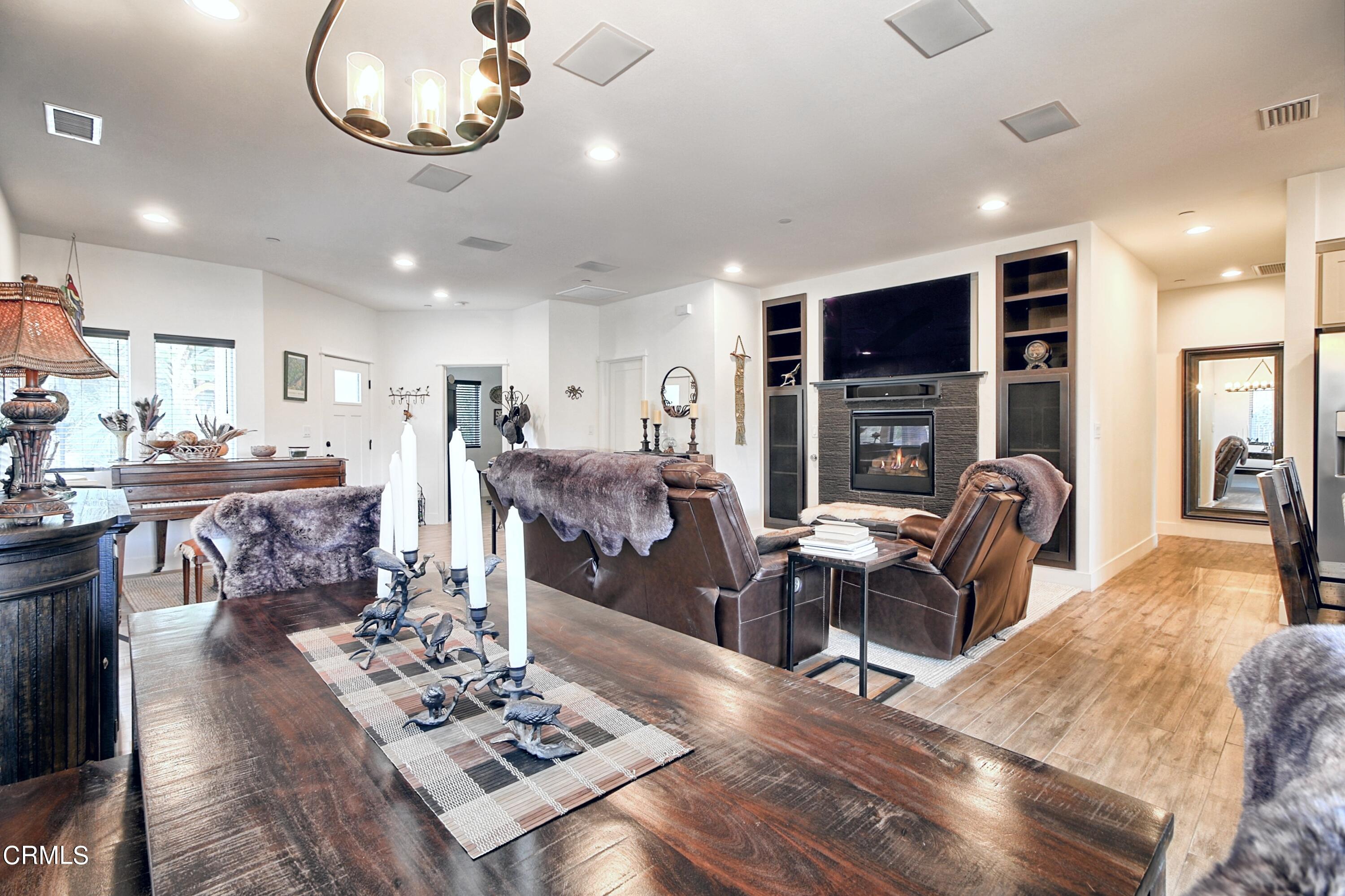 357 Los Cabos Lane Ventura, CA 93001 - Photo 34 of 44 a living room with furniture a flat screen tv and kitchen view