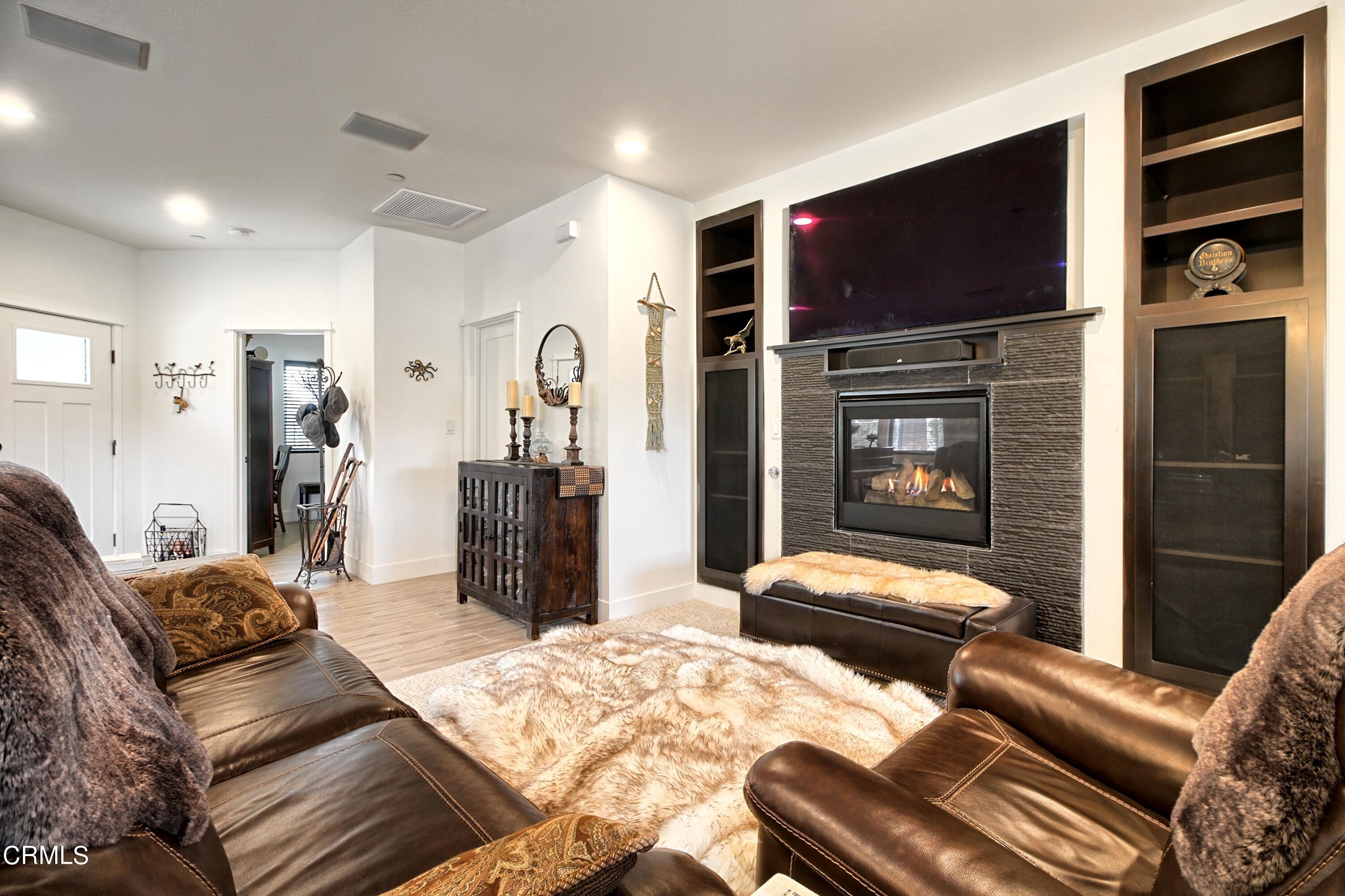 357 Los Cabos Lane Ventura, CA 93001 - Photo 7 of 44 a living room with furniture a flat screen tv and a fireplace