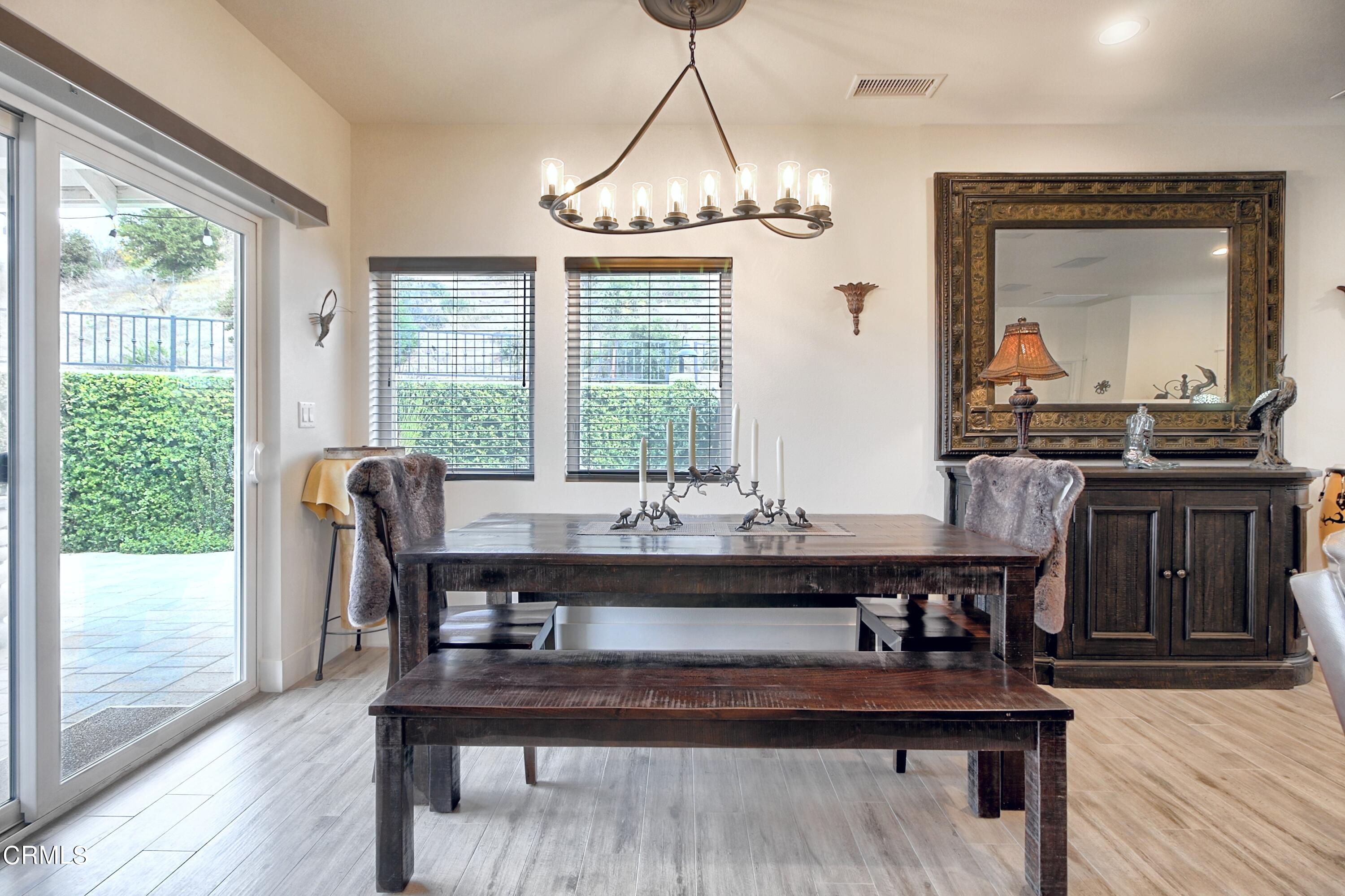 357 Los Cabos Lane Ventura, CA 93001 - Photo 9 of 44 a view of a dining room with furniture window and wooden floor