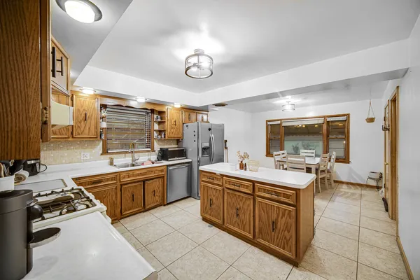 a kitchen with a sink stove and cabinets