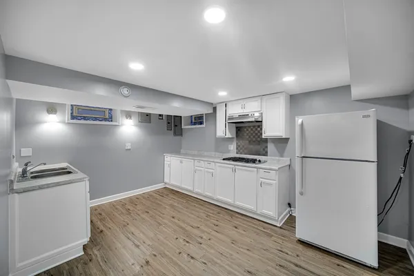 a room with wooden floor and furniture