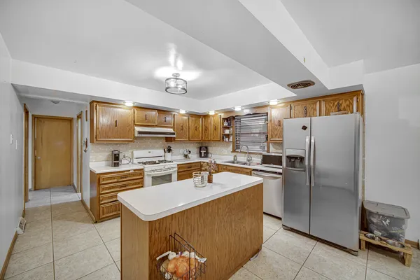 a kitchen with a refrigerator a sink and a stove