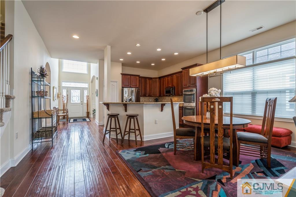 118 Cobblestone Boulevard Monroe Township, NJ 08831 - Photo 12 of 34 a living room with lots of furniture and kitchen view