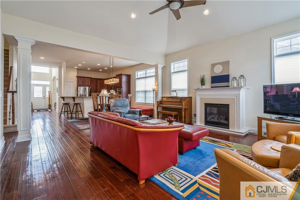 118 Cobblestone Boulevard Monroe Township, NJ 08831 - Photo 13 of 34 a living room with fireplace furniture and a wooden floor