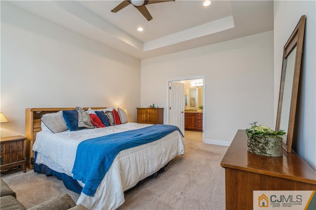 118 Cobblestone Boulevard Monroe Township, NJ 08831 - Photo 15 of 34 a bedroom with a bed and a potted plant on dresser