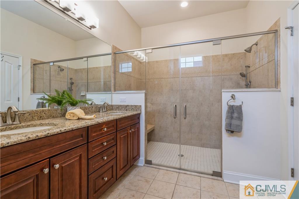 118 Cobblestone Boulevard Monroe Township, NJ 08831 - Photo 16 of 34 a bathroom with a granite countertop shower sink and mirror