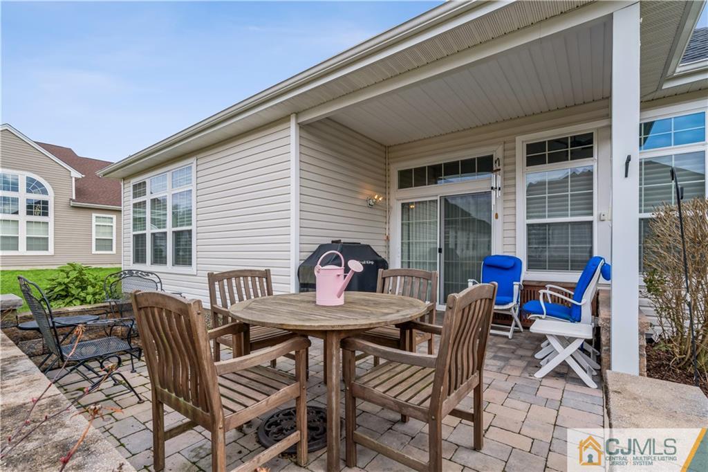 118 Cobblestone Boulevard Monroe Township, NJ 08831 - Photo 26 of 34 a view of a dinning table and chairs in the patio