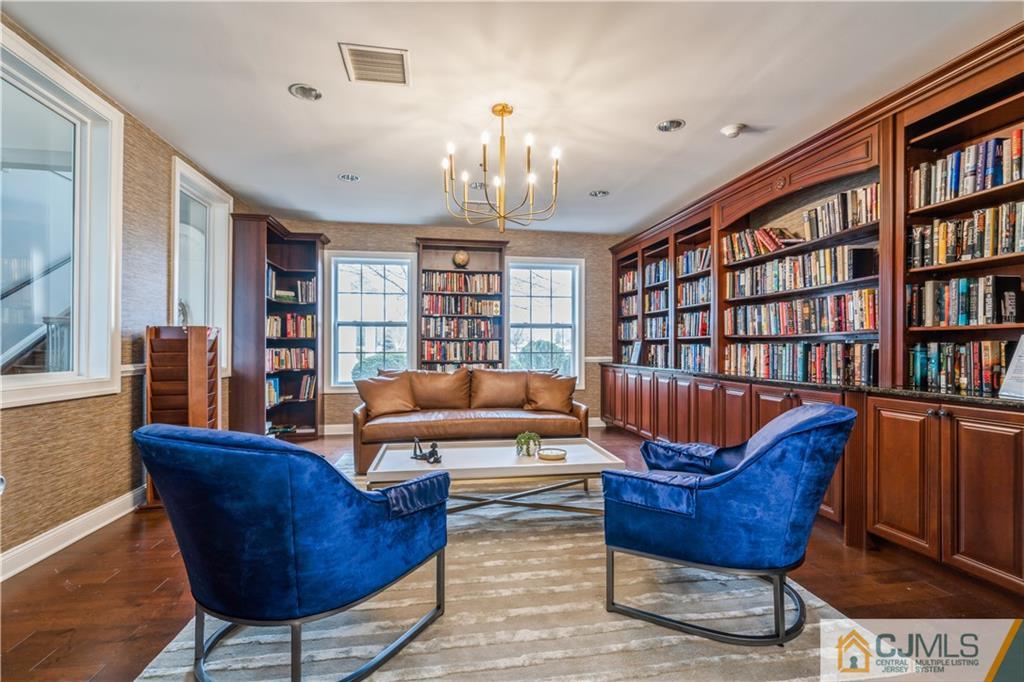 118 Cobblestone Boulevard Monroe Township, NJ 08831 - Photo 31 of 34 a living room with furniture a bookshelf and a book shelf