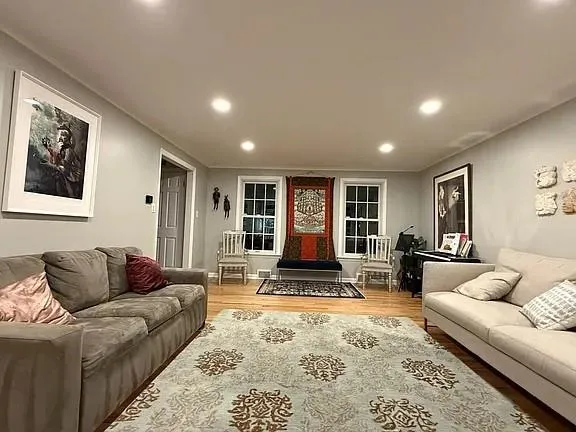 a living room with furniture and large window