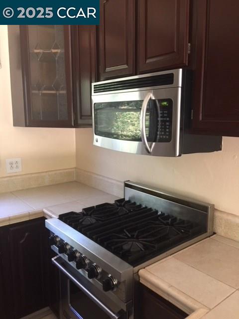 1000 Sanders Drive Moraga, CA 94556 - Photo 18 of 32 a close view of a stove a microwave and cabinets