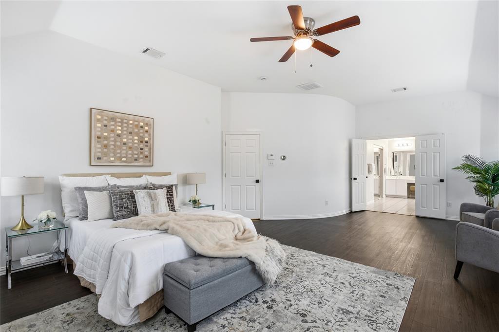 5201 Geode Lane McKinney, TX 75072 - Photo 19 of 37 The primary bedroom is exceptionally large with a beautiful curved accent wall. Gives it a metropolitan vibe.