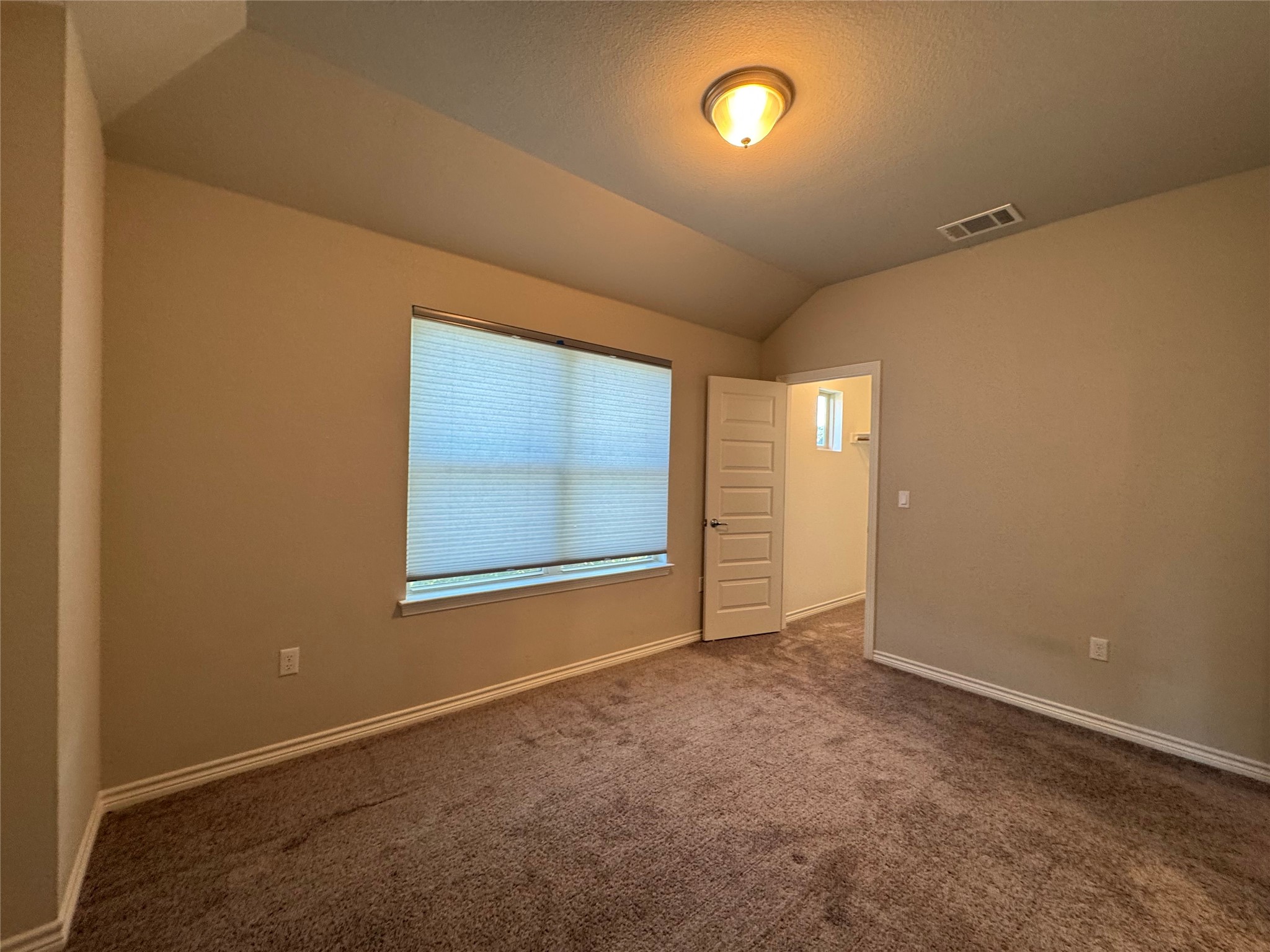 14100 McCoy Loop, Unit 1 Austin, TX 78717 - Photo 23 of 39 A well-proportioned bedroom with ample natural light and plush carpeting throughout.