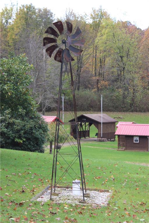 190 Leslie Road Valencia, PA 16059 - Photo 11 of 25 Windmill decoration and out buildings are on the righthand side of the home.