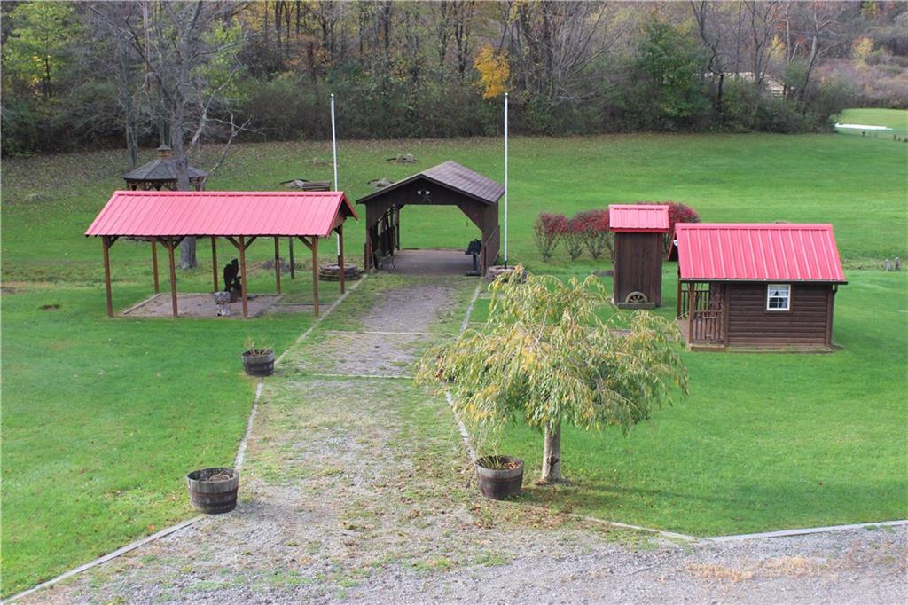 190 Leslie Road Valencia, PA 16059 - Photo 12 of 25 In the extended rear property area is a playroom/shed, outhouse (model only), covered pavilion w/ electricity & lights, covered bridge w/ electricity that spans a playful creek, and a gazebo w/ electricity.