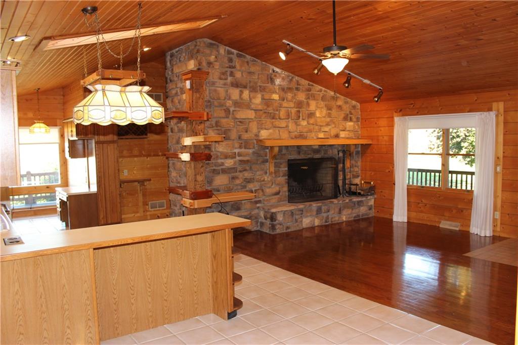 190 Leslie Road Valencia, PA 16059 - Photo 13 of 25 OPEN CONCEPT Living Room & Kitchen area. Features cedar & pine walls, vaulted ceiling, skylights, recessed & fixtures lighting, lots of nature window lighting, oak & ceramic flooring, gorgeous stone wood-burning fireplace, wraparound kitchen counter-height seating, Eat-in Kitchen area, a window Bistro sitting area, a coffee station & expansive storage area and more.