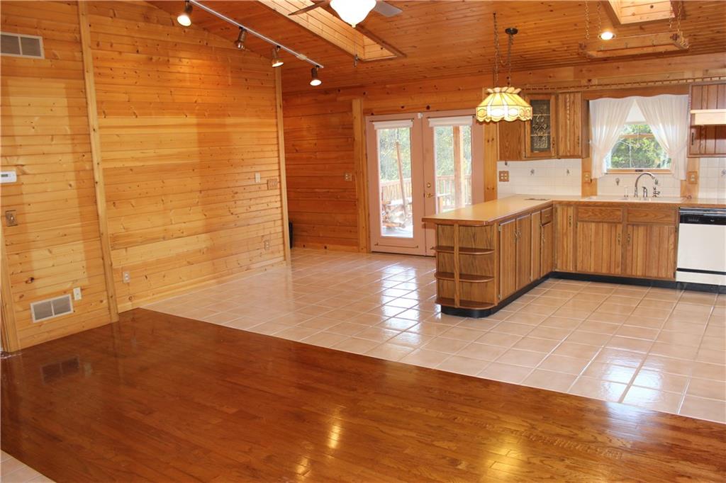 190 Leslie Road Valencia, PA 16059 - Photo 15 of 25 Living room/Kitchen view 3. This view highlights track lighting, Eat-in kitchen area, outdoor upper deck access and hallway to attached garage (by deck access door).