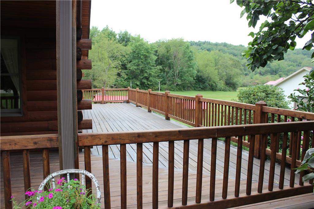 190 Leslie Road Valencia, PA 16059 - Photo 3 of 25 HUGE side wraparound deck connects covered front porch to the covered & open rear deck. Look at what you see!