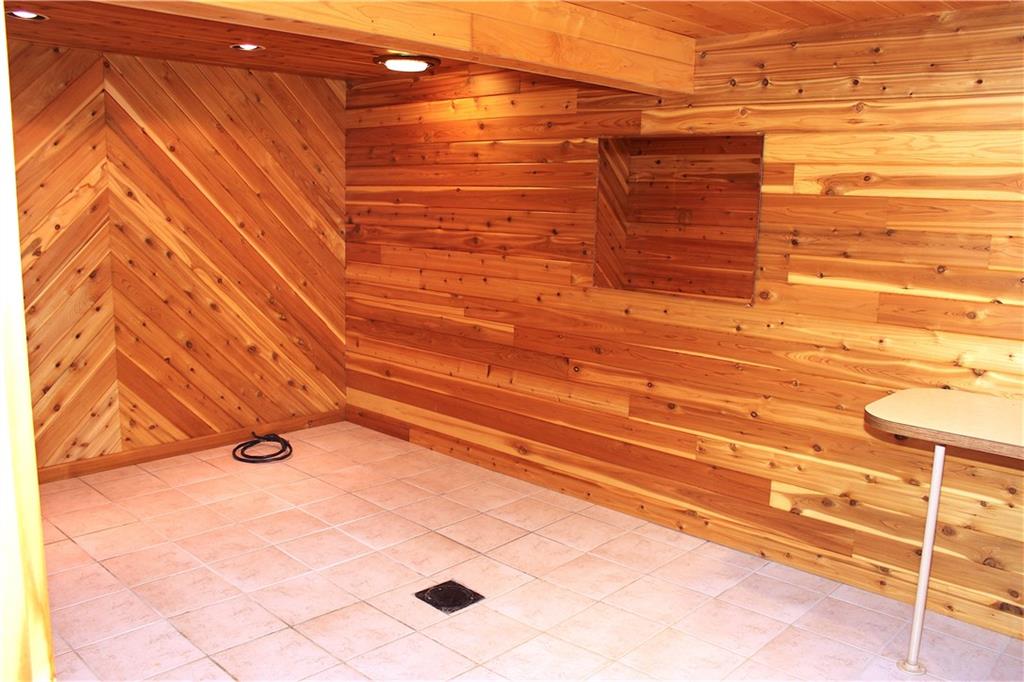190 Leslie Road Valencia, PA 16059 - Photo 23 of 25 Lower Level room was originally designed as a 'Hot Tub Room". Complete with cedar boards, heating elements, hot & cold running water, ceramic complete w/ floor drain, feature spot and recessed lighting. Would also make a wonderful overnight room, home office or Man Cave.