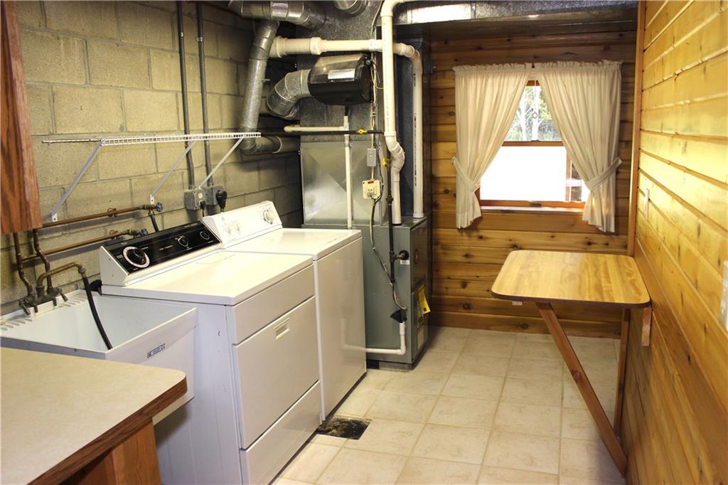 190 Leslie Road Valencia, PA 16059 - Photo 25 of 25 Complete Laundry Center Room, complete with ceramic flooring w/ drain, utility sink, storage tables & cabinet, and more storage in "L" shaped area to the upper right of this image. Washer & Dryer included.