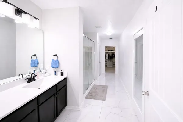 a en suite bathroom with a sink double vanity and a mirror