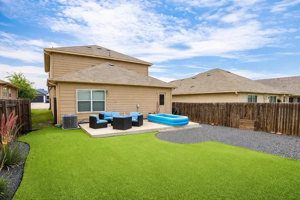 a view of a house with backyard and sitting area