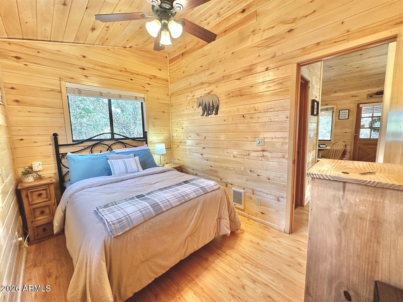 2742 Fox Trail Overgaard, AZ 85933 - Photo 11 of 19 a bedroom with a bed and a flat screen tv