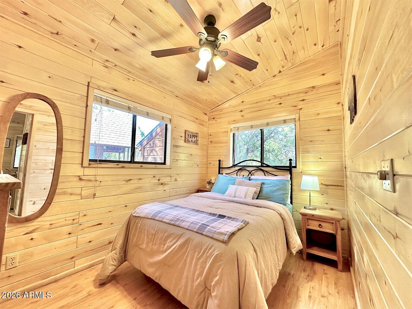 2742 Fox Trail Overgaard, AZ 85933 - Photo 12 of 19 a bedroom with a bed and a chandelier