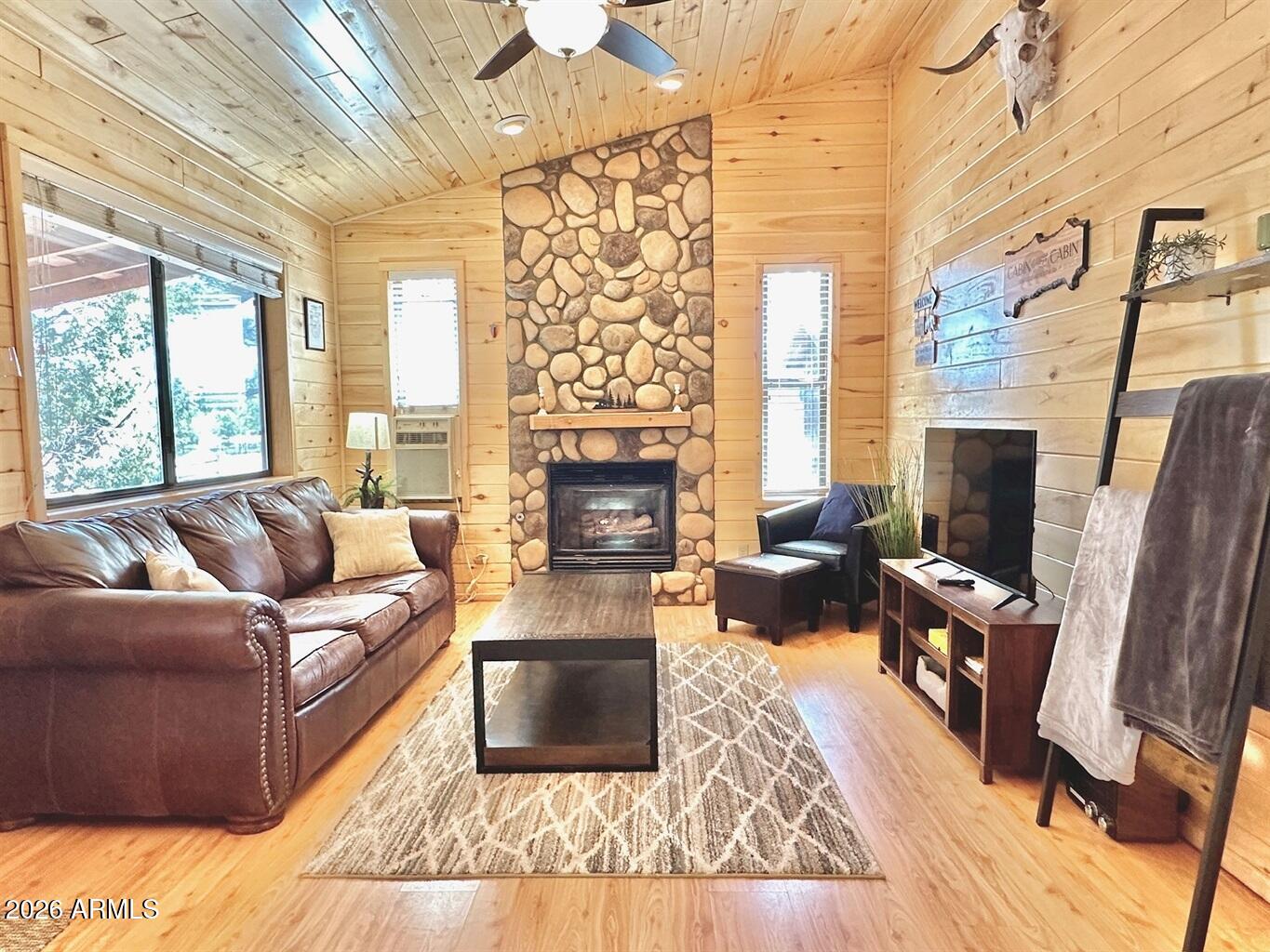 2742 Fox Trail Overgaard, AZ 85933 - Photo 4 of 19 a living room with fireplace furniture and a flat screen tv