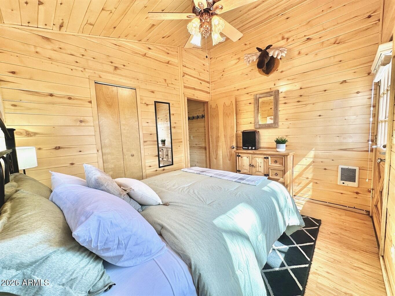 2742 Fox Trail Overgaard, AZ 85933 - Photo 9 of 19 a spacious bedroom with a bed and wooden floor