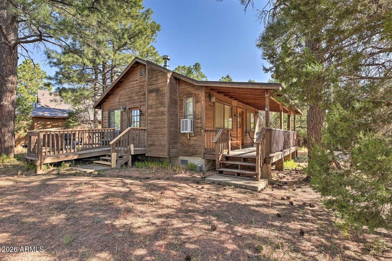 2742 Fox Trail Overgaard, AZ 85933 - Photo 10 of 19 a view of a house with a yard and wooden fence