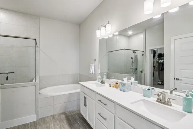 a bathroom with a bathtub a sink and a mirror