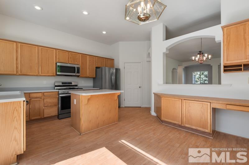 5540 Daybreak Drive Reno, NV 89523 - Photo 12 of 22 a kitchen with stainless steel appliances granite countertop a stove top oven a sink and a refrigerator