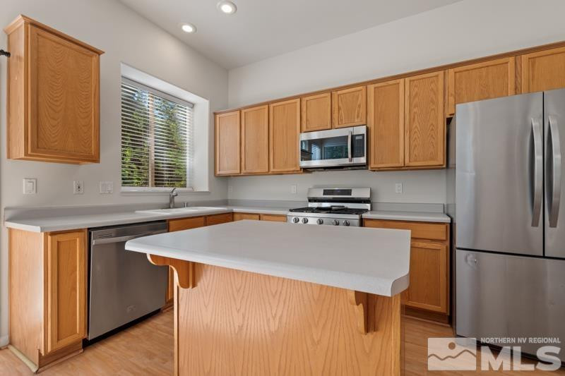 5540 Daybreak Drive Reno, NV 89523 - Photo 13 of 22 a kitchen with stainless steel appliances a refrigerator stove microwave and sink