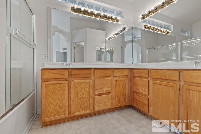 5540 Daybreak Drive Reno, NV 89523 - Photo 19 of 22 a bathroom with a sink a mirror and a vanity