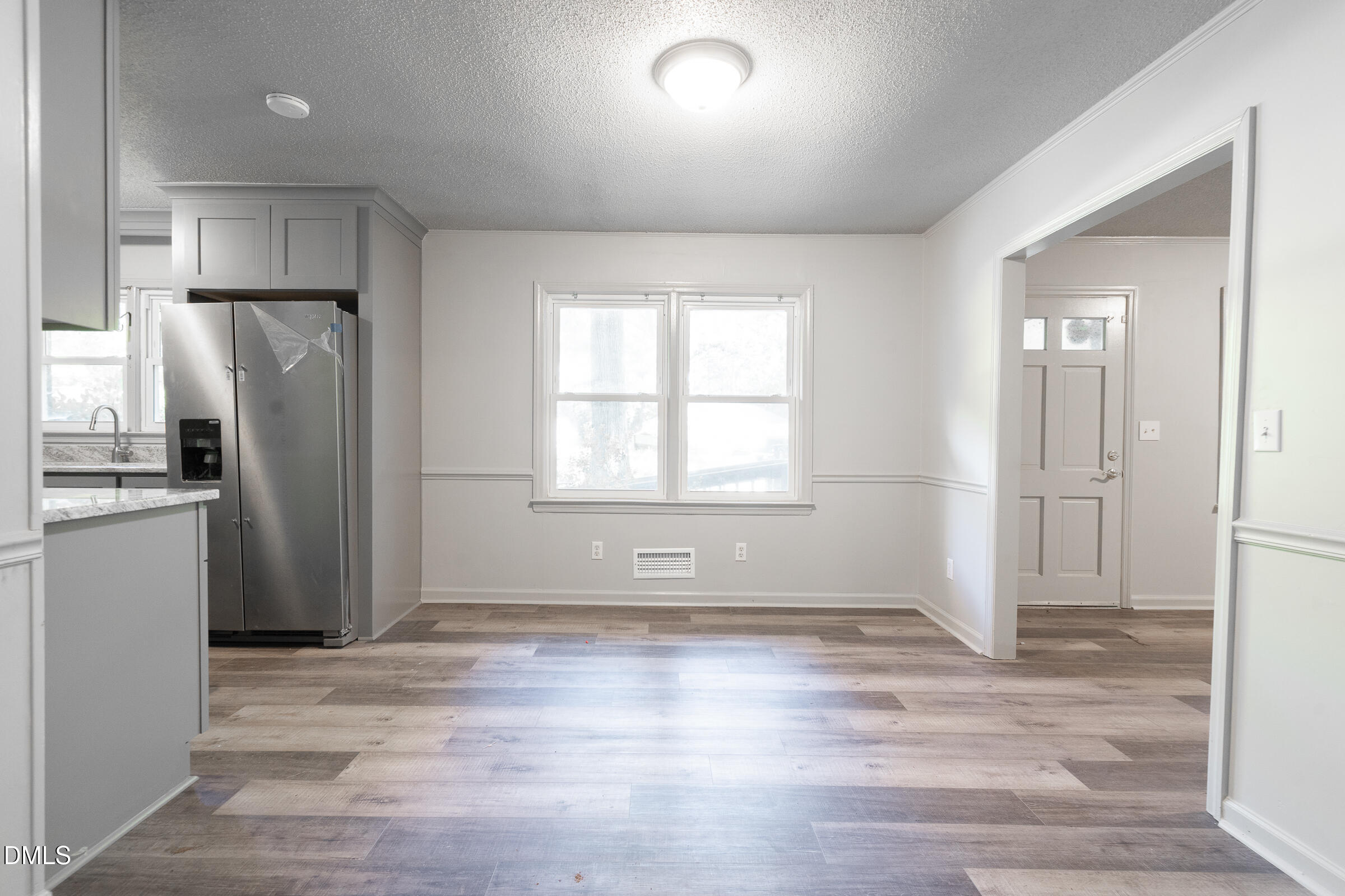 807 Grovemont Road Raleigh, NC 27603 - Photo 11 of 22 a view of a kitchen with refrigerator and wooden floor