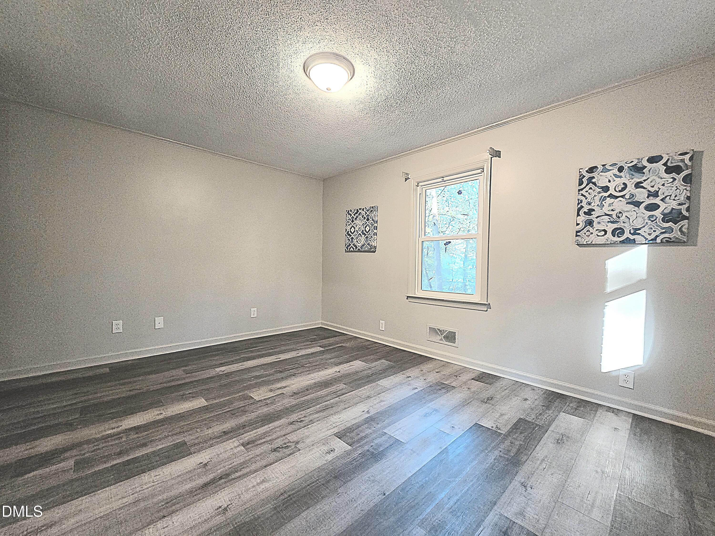 807 Grovemont Road Raleigh, NC 27603 - Photo 13 of 22 wooden floor in an empty room with a window