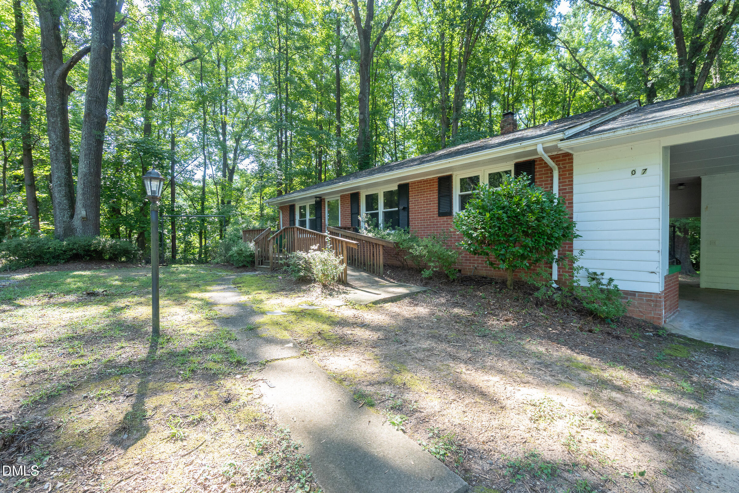 807 Grovemont Road Raleigh, NC 27603 - Photo 3 of 22 a view of a house with backyard and garden