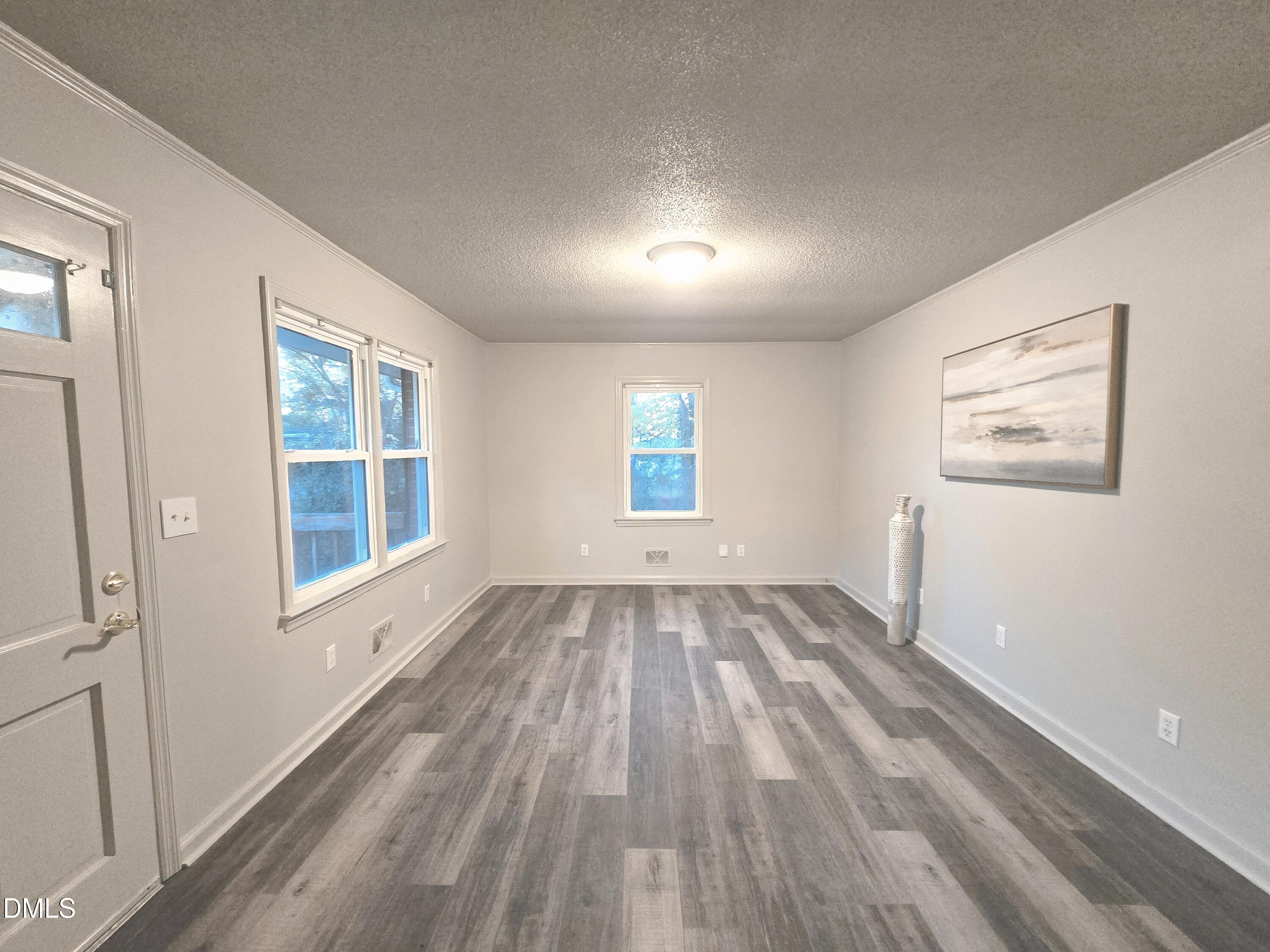 807 Grovemont Road Raleigh, NC 27603 - Photo 5 of 22 wooden floor in an empty room with a window