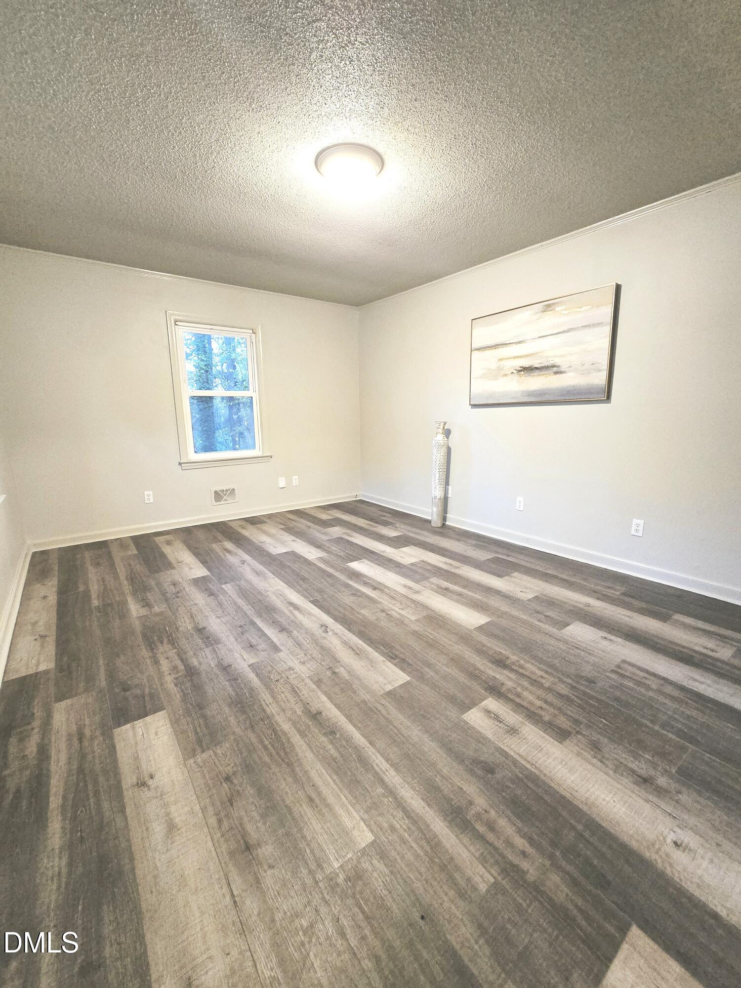 807 Grovemont Road Raleigh, NC 27603 - Photo 6 of 22 a view of empty room with wooden floor