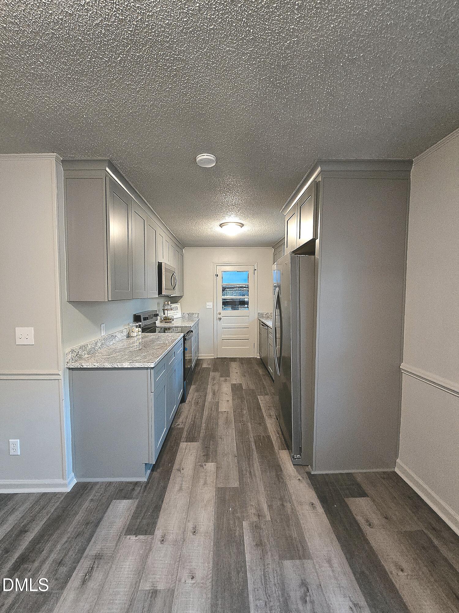 807 Grovemont Road Raleigh, NC 27603 - Photo 7 of 22 a view of a kitchen with a sink and wooden floor