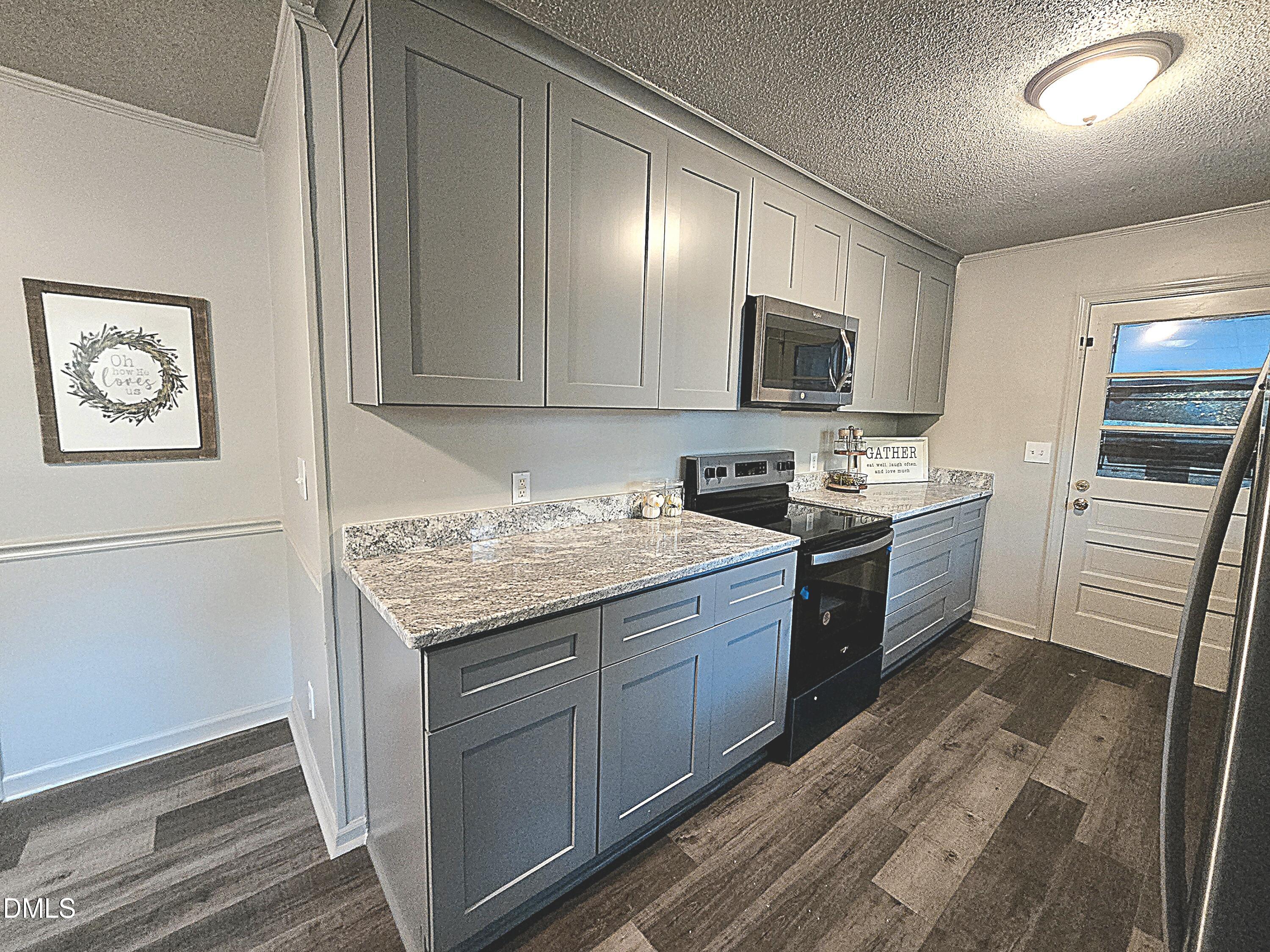 807 Grovemont Road Raleigh, NC 27603 - Photo 8 of 22 a kitchen with granite countertop stainless steel appliances and wooden cabinets
