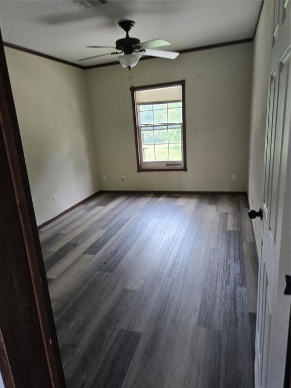 1331 Jay Bird Road Springtown, TX 76082 - Photo 12 of 18 an empty room with wooden floor fan and windows