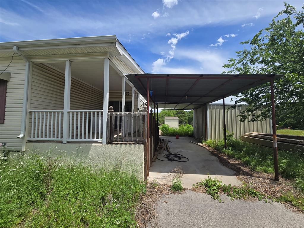 1331 Jay Bird Road Springtown, TX 76082 - Photo 3 of 18 a view of a porch with a garden