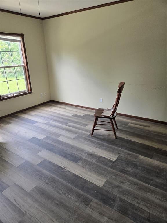 1331 Jay Bird Road Springtown, TX 76082 - Photo 7 of 18 a view of an empty room with wooden floor and a window
