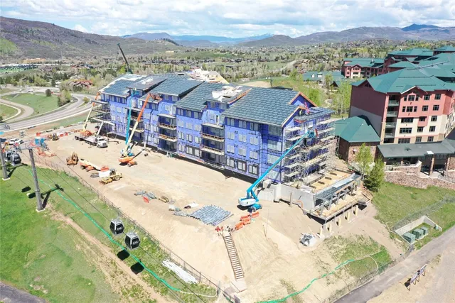 an aerial view of residential houses with outdoor space and river